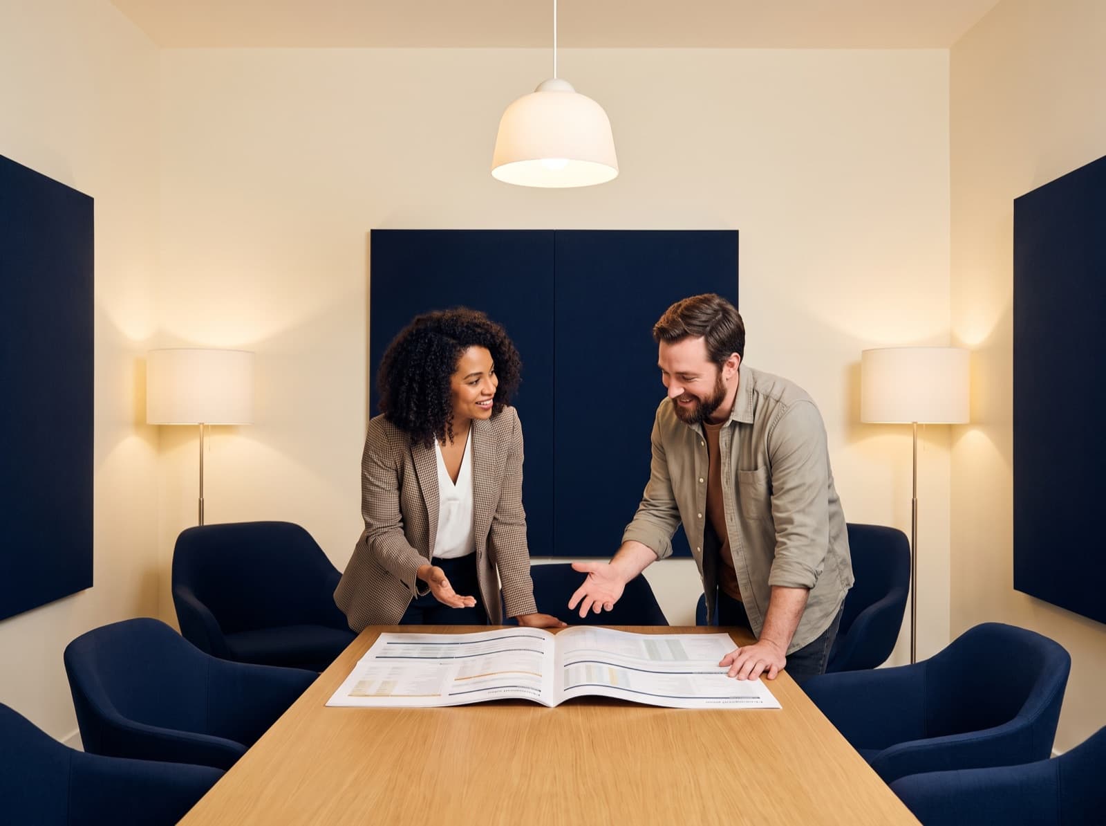 Advisor meeting with a client over a printed plan